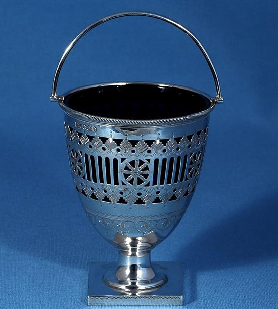 A late Victorian silver swing handled sugar basket with a blue glass liner, by Atkin Brothers, height 165mm, weight 4.9oz/154grms.